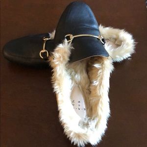 Fuzzy slip on shoes.